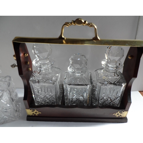 123 - Edwardian 3 bottle tantalus together with an additional decanter