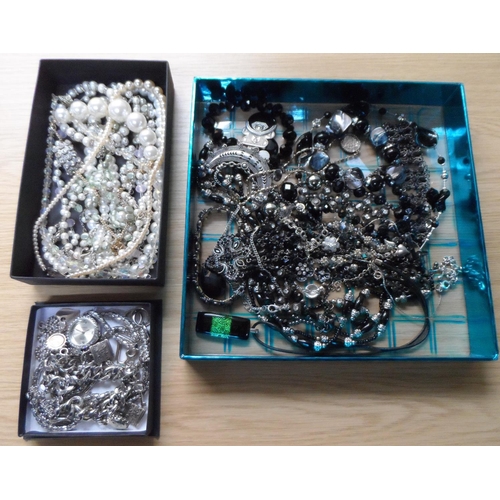 69 - Three small trays of costume jewellery to include a silver coloured charm bracelet etc (Qty)