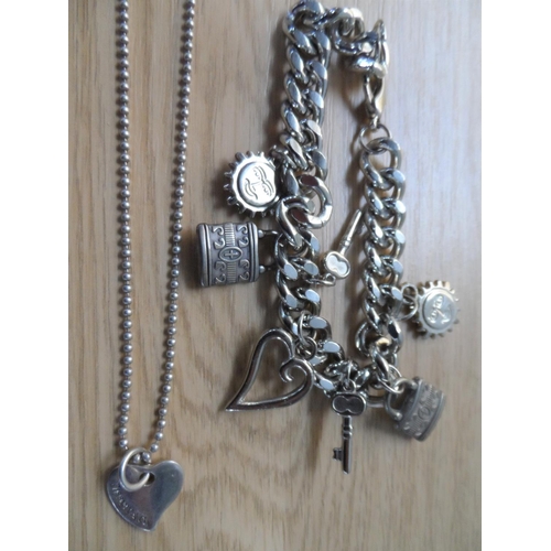 69 - Three small trays of costume jewellery to include a silver coloured charm bracelet etc (Qty)