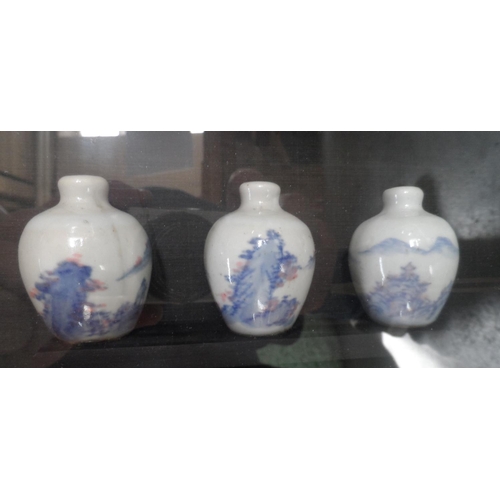 143 - Two gilt framed pictures, one containing two Chinese blue & white signed bowls together with another... 