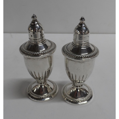 2 - A pair of Sterling silver salt and pepper pots, weighted bases, (2)