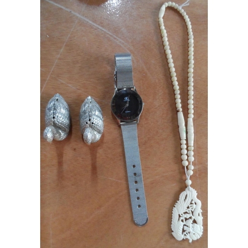 37 - Calvin Klein wrist watch with silvered metal strap together with carved bone pendant and necklace et... 