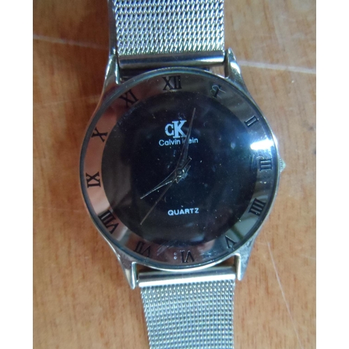 37 - Calvin Klein wrist watch with silvered metal strap together with carved bone pendant and necklace et... 
