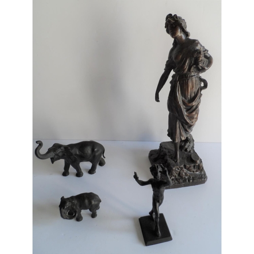 99 - Two unmarked bronze elephants together with a small bronze figure of Pan and an antique spelter figu... 