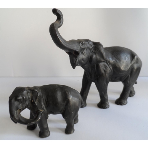 99 - Two unmarked bronze elephants together with a small bronze figure of Pan and an antique spelter figu... 