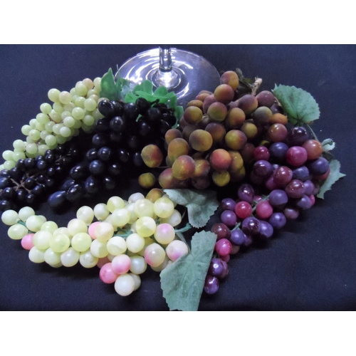 101 - Oversized, stylist wine glass, approx 50cm tall with a huge amount of plastic fruit (Qty)