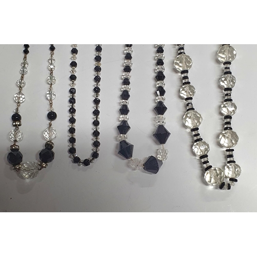 39 - 5 Jet and antique glass necklaces,

Longest necklace 122cm  shortest 34 cm
