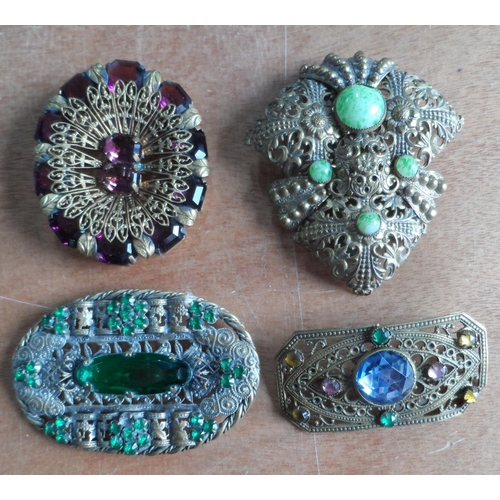 49 - Collection of 9 filigree metal & coloured stone brooches together with a mid 20thC metal sunburst br... 