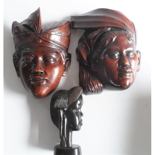 70 - Pair of carved south east Asian wooden face masks together with an African hardwood carving (3)