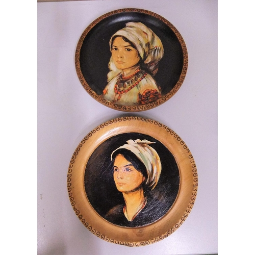 53 - Pair of unsigned, oil on wooden plate portraits of ladies (2),

Both plates measure 25 cm diameter