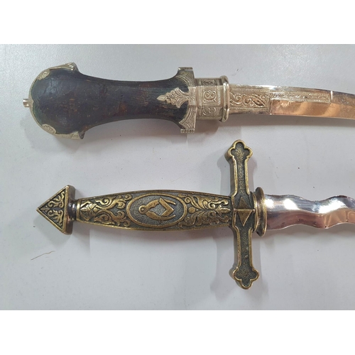 145 - Replica Masonic sheather dagger together with an ornate Arabic sheathed dagger (2)