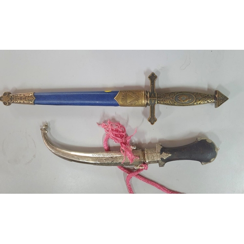 145 - Replica Masonic sheather dagger together with an ornate Arabic sheathed dagger (2)