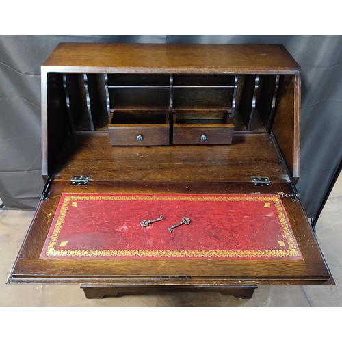 919 - A mid-century bureau with drop-front revealing red leather inlay, two drawers and compartments, with... 