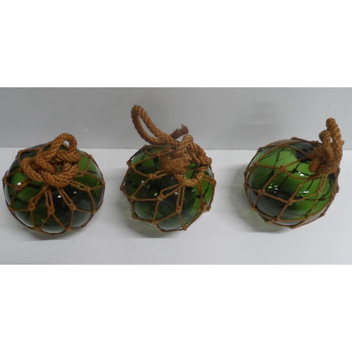 480 - Three decorative Batna jugs together with three netted green glass fishing balls (6)