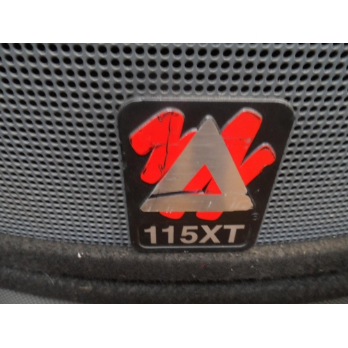 311 - A pair of Peavey X series 115XT PA speakers with side carry handles and metal pole inserts