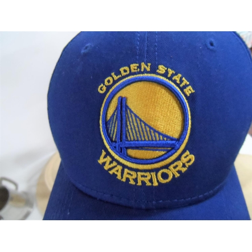 255 - Three Panama style hats and a Golden State Warriors (basketball, San Francisco) together with a tank... 