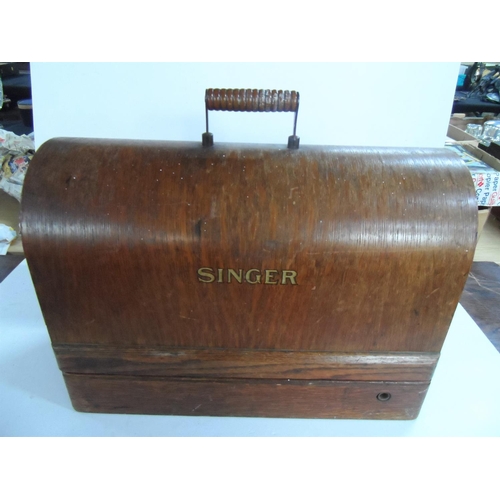 230 - Antique Singer sewing machine complete with original wooden cover