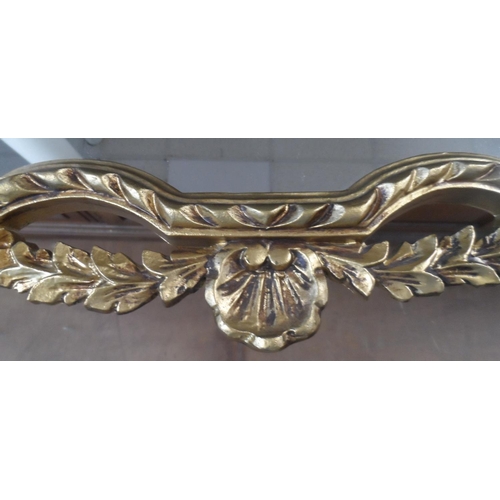 565 - An ornate gilt framed mirror