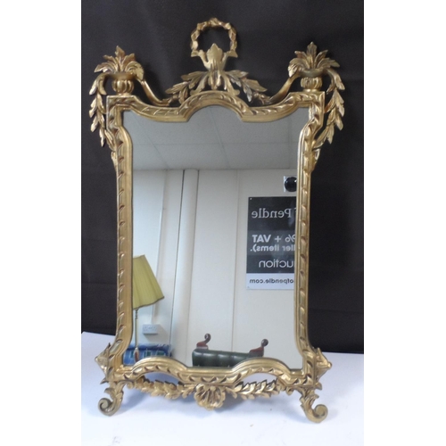 565 - An ornate gilt framed mirror