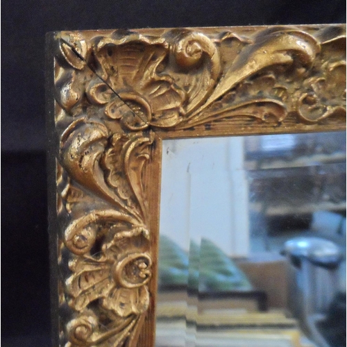 567 - Oblong, bevelled edged mirror in ornate gilt frame