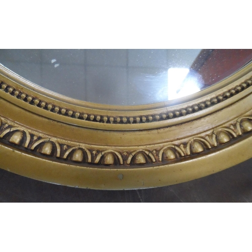 569 - Gilt framed, oval wall mirror