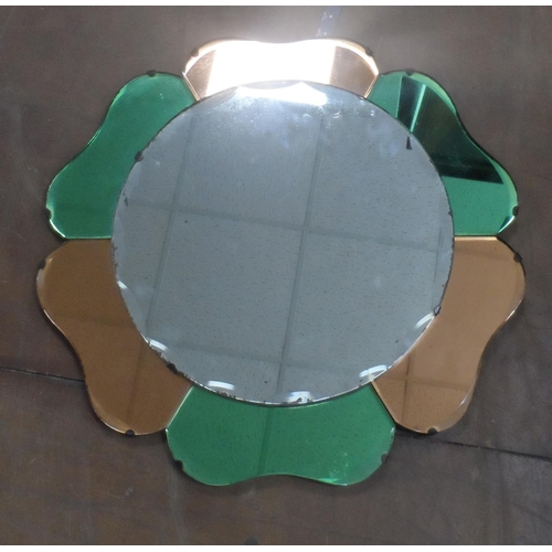 573 - Coloured glass, flower-head Art Deco style mirror together with an oval mirror (2)