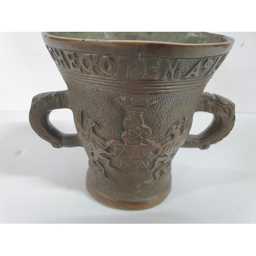 275 - Two handled 20thC bronze cup with all-round inscription and decoration,

12 cm tall           1250 g... 