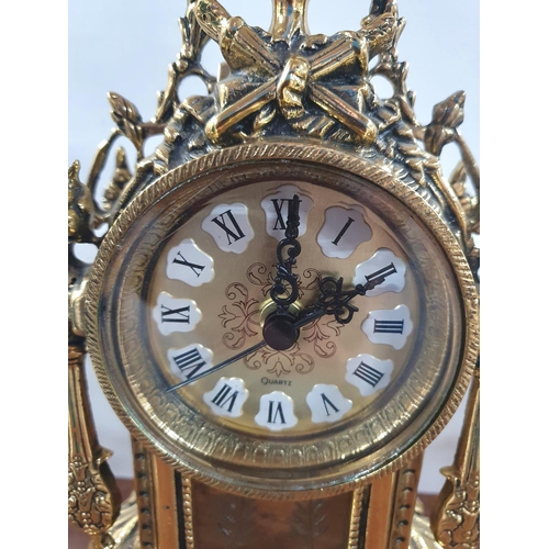 270 - Ornately cast, unmarked, 20thC French style, enamelled faced mantle clock flanked by ornate brass ca... 