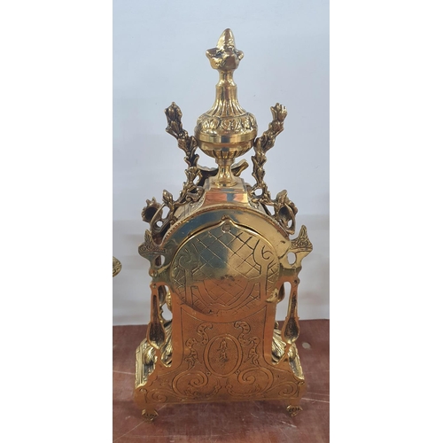 270 - Ornately cast, unmarked, 20thC French style, enamelled faced mantle clock flanked by ornate brass ca... 