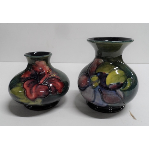 1046 - TWO VINTAGE MOORCROFT 'HIBISCUS' PATTERN SQUAT VASES (2),

Both with paper labels to base,

8cm & 10... 