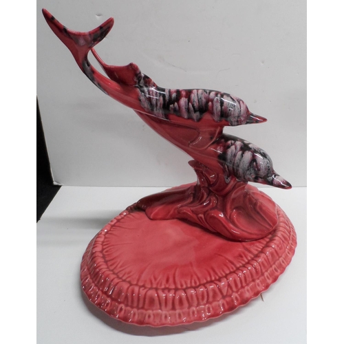 1080 - Large unmarked table centre-piece depicting two Dolphins riding a wave on a circular base