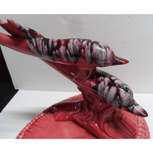 1080 - Large unmarked table centre-piece depicting two Dolphins riding a wave on a circular base