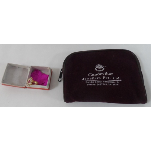 20 - Interesting, unmarked Indian gold coloured metal ring with a large central ruby surrounded by uniden... 