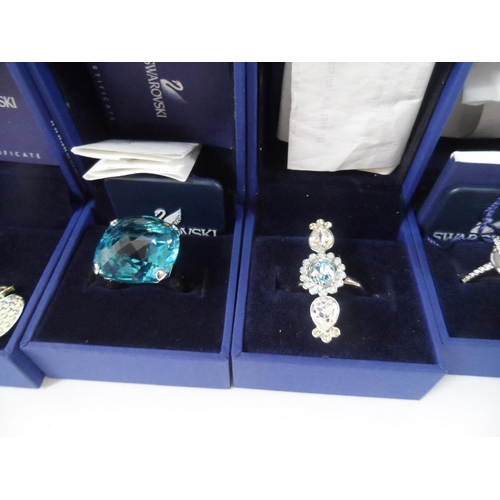 34 - Three Swarovski, boxed, as new, rings together with two other boxed Swarovski items (5)