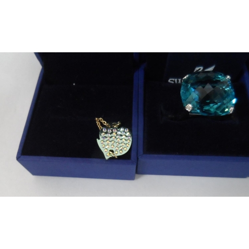 34 - Three Swarovski, boxed, as new, rings together with two other boxed Swarovski items (5)