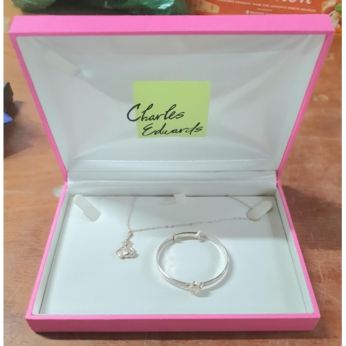 36 - Childs silver christening set to include a silver teddy pendent on a silver chain and matching silve... 