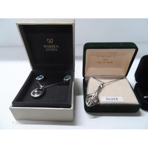 76 - Boxed silver pendant and necklace together with a boxed necklace, pendant and earrings set from Warr... 