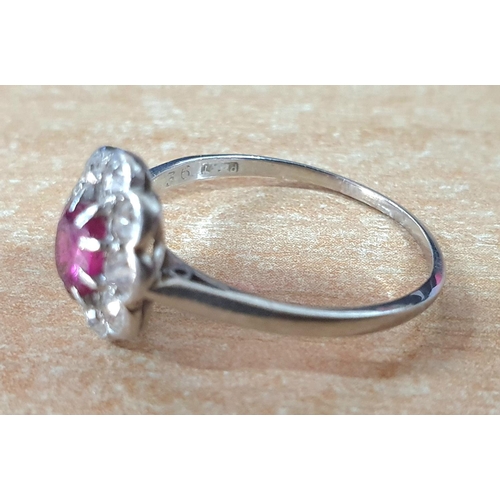 80 - Platinum flower ring with a large Pink Sapphire surrounded by 9 round cut diamonds,

3.1 grams gross... 