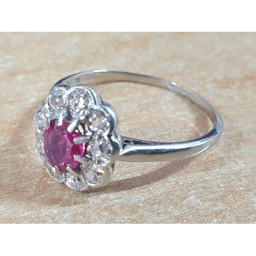 80 - Platinum flower ring with a large Pink Sapphire surrounded by 9 round cut diamonds,

3.1 grams gross... 