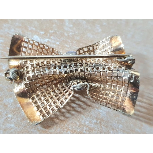 82 - Finely worked 9ct yellow and white gold brooch in the form of a tied bow,

2.4 grams