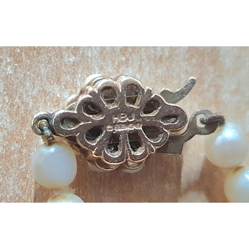 95 - Early 20thC Pearl choker with 9ct gold backed clasp, the front containing a round cut Sapphire surro... 