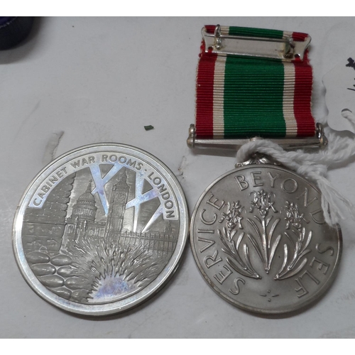 176 - Cased Women's Voluntary Service medal together with a cased Cabinet War Rooms nickel-silver coin (2)