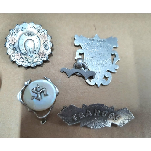 14 - Collection of mainly slver items to include a napkin ring, cut glass jar lid, pendants and cap badge... 