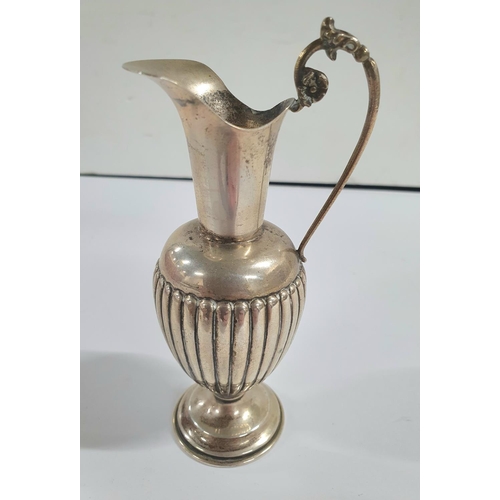 6 - Indistinctly marked silver bud vase in the form of a classical jug, weighted base,

75 grams gross  ... 