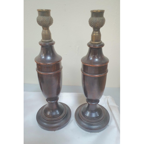 69 - Pair of fine quality, early 20thC, antique turned wooden candle sticks together with a pair of woode... 