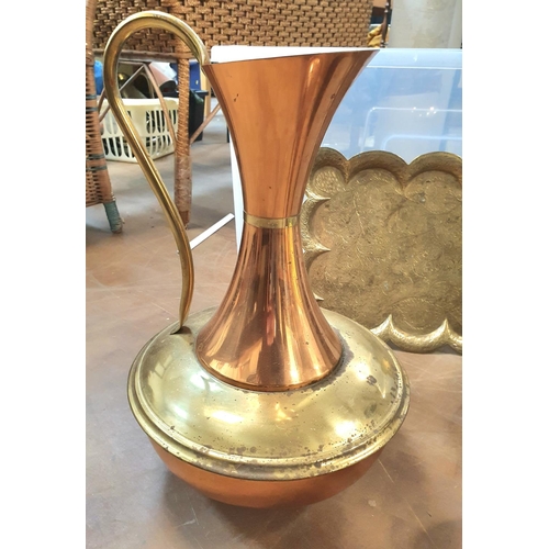 131 - Two large north African metal jugs together with a smaller copper example and a good quality beaten ... 