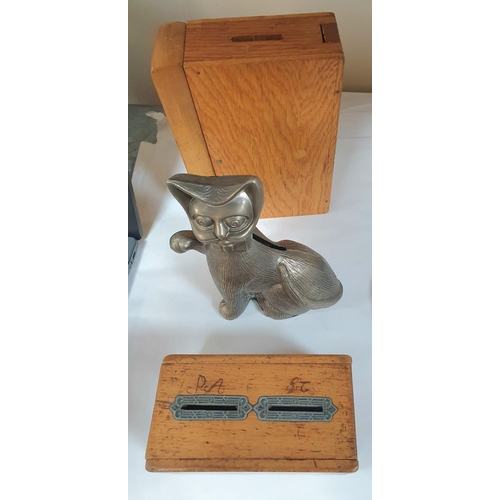 202 - Collection of old savings boxes including a metal cat example together with an early 20thC wooden pe... 