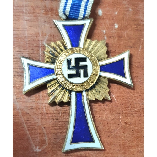 186A - 1938 Nazi party gold mothers enamelled cross together with SS insignia etc (4)