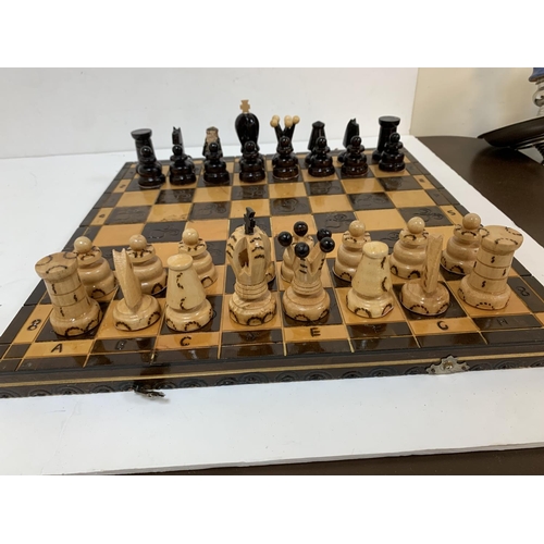 282 - Foldable wooden chess board with unusual carved wooden pieces