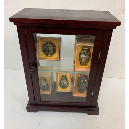 319 - Small display case containing 5 boxed, small, hand painted Oriental ceramic items